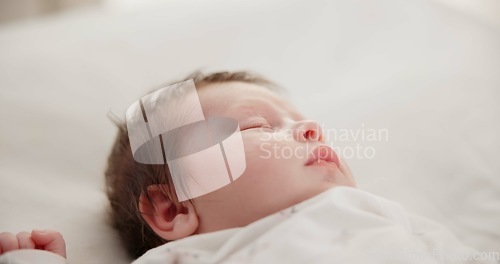 Image of Baby, face and sleeping in the morning on nursery bed and blanket with nap and rest. Relax, calm and tired newborn with youth on bedding with kid sleeping from above in a family home and bedroom