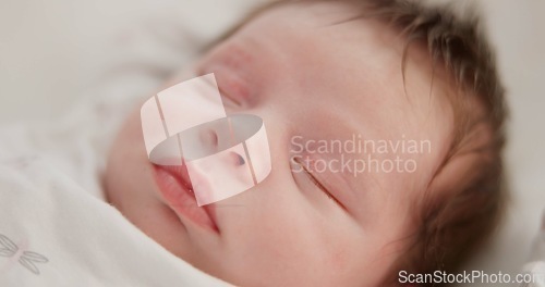Image of Baby, sleeping face and nursery bed with morning, nap and dreaming of a young newborn at home. Cozy, sleepy kid and calm with health development from rest and peace in a house with closeup and care