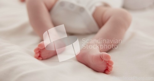 Image of Sleeping, adorable and feet of baby on bed for child care, dreaming and relax in nursery. Family, cute and closeup of toes of innocent newborn infant for health, wellness and development at home