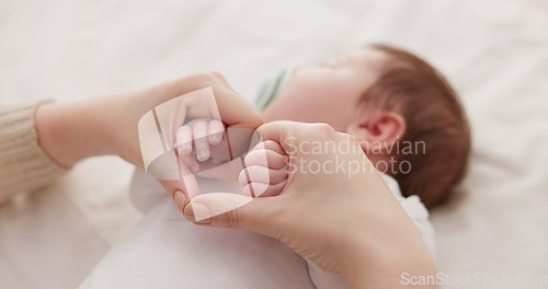 Image of Bed, holding hands and mother with baby, love and support for care, health and wellness at home. Fingers, family or mama with a healthy infant, protection and child development with bond or maternity