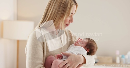 Image of Family, kiss and a mother rocking her baby to sleep in the bedroom of their home together for love or care. Dreaming, nap or tired with a woman and newborn infant in an apartment to rest for growth