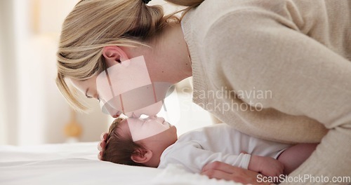Image of Happy, mother and baby kiss with love, care and support in a home with newborn and bonding. Morning, mom and relax infant with child security and motherhood in a family home on a bed with mama