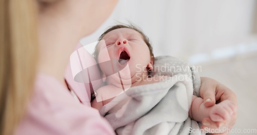 Image of Baby, yawn and calm with tired newborn and mom in a bedroom at morning with care. Rest, relax and young kid with fatigue and mother support in a family home with motherhood in house with blanket