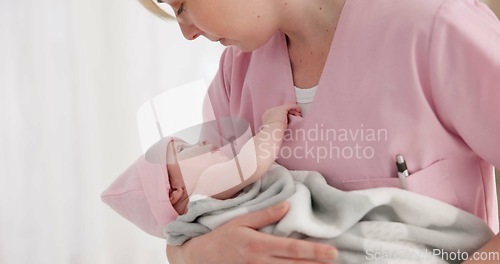 Image of Nurse, woman and newborn in hospital for wellness, medical checkup or examination with support or care. Pediatrician, professional and holding baby in clinic with bond and relax for child development