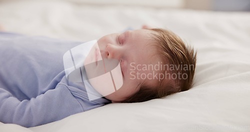 Image of Relax, growth and sleep with a baby on a bed closeup in a home, dreaming during a nap for child development. Kids, calm and rest with an adorable newborn infant asleep in a bedroom for comfort