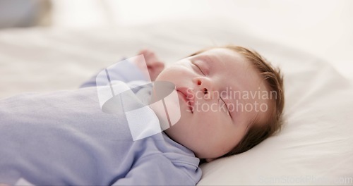 Image of Relax, growth and sleep with a baby in a bedroom closeup in a home, dreaming during a nap for child development. Kids, calm and rest with an adorable newborn infant asleep on a bed for comfort