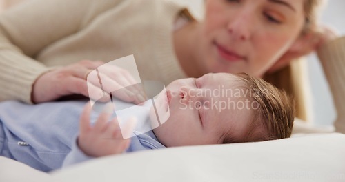 Image of Family, love and a mama on the bed with her baby for sleep, rest or bonding together in a home. Children, bedroom and a single mom in an apartment with her newborn infant to relax for care or growth