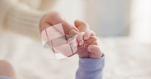 Image of Sleeping, family and holding hands with baby on bed for bonding, love and relationship with infant. Adorable, care and closeup of parent with newborn for support, dreaming and protection at home