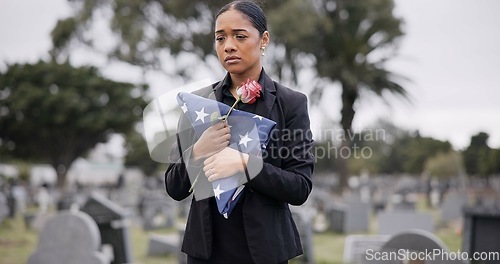 Image of Funeral, rose and american flag with a woman at a cemetery in mourning at a memorial service. Sad, usa and an army wife as the widow of a patriot in a graveyard, feeling pain of death, loss or grief