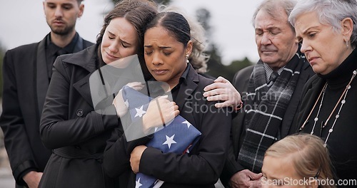 Image of Sad, family and funeral with comfort, woman and support with compassion, empathy and depression. People, wife of loved one and friends with love, USA flag and sympathy with grief, goodbye or remember