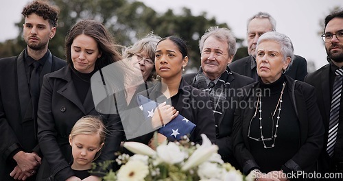 Image of Funeral, cemetery and family with American flag for veteran for respect, ceremony and memorial service. Sad, depression and people by coffin in graveyard for military hero, army and soldier mourning