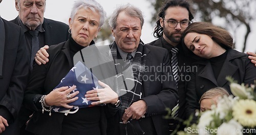 Image of Funeral, cemetery and family with USA flag for veteran for respect, ceremony and memorial service. Remembrance, depression and sad people by coffin in graveyard mourning military, army and soldier