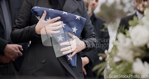 Image of Hands, american flag and death with a person at a funeral, mourning a loss in grief at a graveyard. War, cemetery and an army wife at a memorial service to say goodbye to a fallen soldier closeup