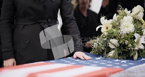 Image of USA veteran funeral, woman and casket with touch, sad family and flag for mourning, depression and respect. Widow, people and army service with coffin, burial or memorial for war hero in Philadelphia