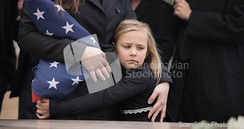 Image of USA veteran funeral, girl and sad family with hug, care and flag for mourning, depression and comfort with mom. Kid, people and service with coffin, burial or memorial with war hero in Philadelphia