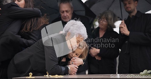 Image of Funeral, crying family and child hug grandmother for support, mourning depression and death at emotional burial event. Dead, love and kid hugging senior woman, grandma and grief at farewell ceremony