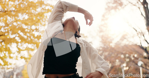 Image of Japanese woman, trees and dancing in park, moving body and freedom for street performance in nature. Girl, dancer and person with art, concert and steps with creativity, face and balance in Tokyo