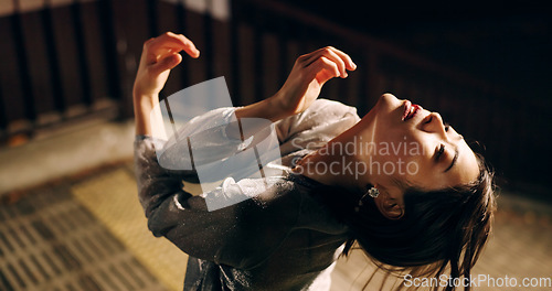 Image of Woman, dancing and street performance at night in Japan for contemporary, outdoor or dark. Asian person, creative and art in urban city or Tokyo metro for music expression, entertainment or confident