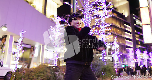 Image of Woman in Japan, dancing in city at night with energy and fun, happiness and freedom outdoor. Celebration, party and music with Japanese dancer on urban street, light and positivity for nightlife