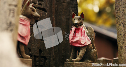 Image of Fox statue at Shinto shrine in forest with spiritual history, Japanese culture and vintage art in nature. Travel, landmark and stone jinja sculpture in woods with stone animal monument, trees and god