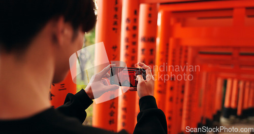 Image of Phone, man and picture of torii gates on vacation, holiday trip or travel for tourism. Smartphone, hands and closeup photography of Fushimi inari-taisha in Kyoto Japan on mobile technology outdoor