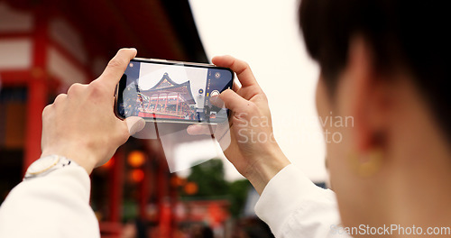 Image of Phone, hands and tourist with picture in Japan on vacation, holiday trip or travel. Smartphone, person and closeup photography of Fushimi inari-taisha temple in Kyoto on mobile technology outdoor