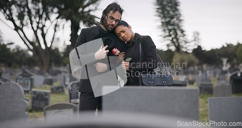 Image of Couple, sad and mourning at tomb of graveyard, funeral and pay respect together outdoor. Death, grief and man and woman at cemetery by casket, empathy and interracial support to console at tombstone