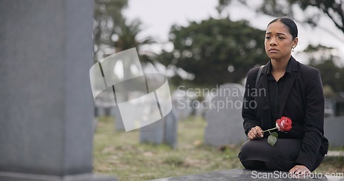Image of Sad woman, graveyard and rose on tombstone in mourning, loss or grief at funeral or cemetery. Female person with flower in depression, death or goodbye at memorial or burial service for loved one