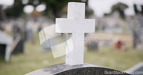 Image of Funeral, graveyard and cross on tombstone for death ceremony, religion or memorial service. Catholic symbol, background or Christian sign on gravestone for mourning, burial or loss in public cemetery