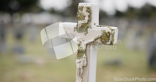 Image of Funeral, tombstone or jesus on cross in graveyard for death ceremony, religion or memorial service. Symbol, background or Christian sign on gravestone for mourning, burial or loss in public cemetery