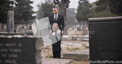 Image of Child, death or father in graveyard for funeral. spiritual service or burial for respect in Christian religion. Rose, depressed or sad kid in cemetery for grief, loss or mourning with dad for support