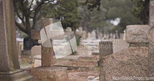 Image of Funeral, cemetery and cross on tombstone for death ceremony, religion or memorial service. Catholic symbol, background or Christian sign on gravestone for mourning, burial or loss in public graveyard