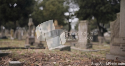 Image of Graveyard, burial and tombstone in cemetery for death ceremony, funeral ritual and memorial service. Headstone, rip and resting place of departed for mourning, loss and remembrance of dead by church