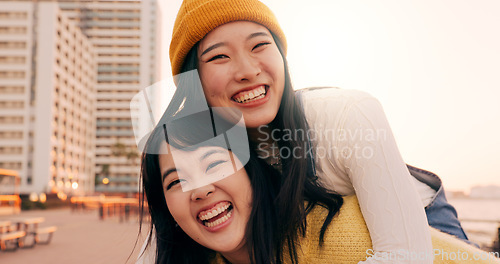 Image of Friends, women and piggyback outdoor on promenade with bonding, laughing and adventure on holiday or vacation. Travel, Japanese people or embrace at beach in city with fun, comedy or freedom together