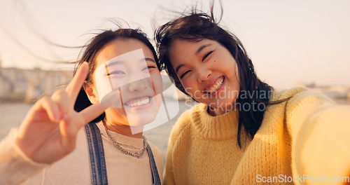 Image of Women, friends and selfie at sea holiday in Japan for travel experience, adventure or happy. Female people, peace sign and face for city tour trip or online connection for summer, social or vacation