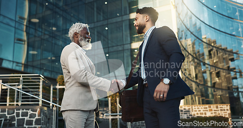 Image of Business men, handshake and meeting in city for b2b partnership, outdoor deal and travel introduction or welcome. Corporate clients and senior boss shaking hands with time or schedule for consulting