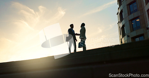 Image of Business people, handshake and city silhouette for partnership, outdoor introduction and travel meeting. Corporate clients or men shaking hands for welcome, hello and agreement or career opportunity
