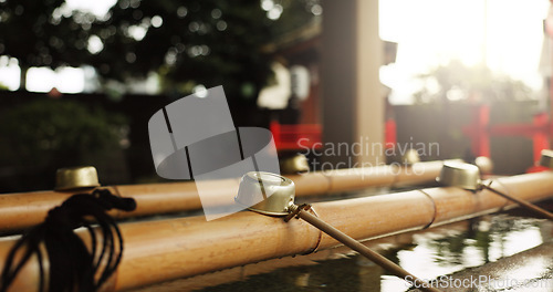 Image of Shinto temple, closeup and fountain with water in container for faith, clean or washing hands for wellness. Religion, mindfulness or praise with purification ritual in woods, peace or shrine in Kyoto