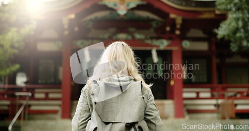 Image of Torii gate, woman or back in japan for worship, holy or prayer location for peace in culture. Kyoto architecture, person and Fushimi Inari Taisha with religion and gateway of sacred to shinto shrine