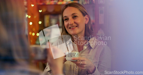 Image of Women, friends and talk in coffee shop, drink and happy for reunion, date and conversation on break. Girl, people and smile for chat, memory and relax with tea cup, latte or espresso in cafe together