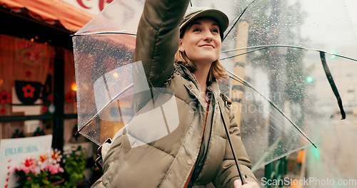 Image of Woman, street and stop taxi with umbrella in rain, smile or winter for travel, transport or driver in city. Girl, person or tourist in metro for bus, driver or chauffeur on road with parasol in Tokyo