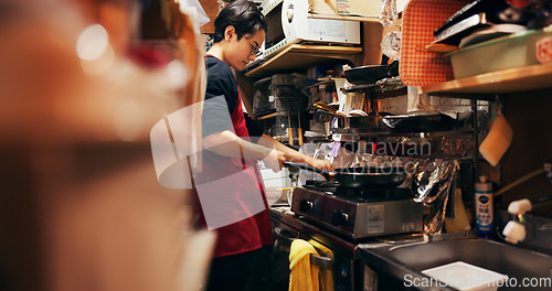Image of Japanese chef man, stove and pan for cooking, service or catering job with heat, flame and ready. Person, restaurant or cafeteria in kitchen for meal prep, working or thinking with recipe in Tokyo