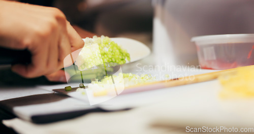 Image of Hands, cut and vegetables on table with knife, japanese food and chef by dinner for healthy diet. Person, cooking and ingredients for vegetarian lunch for nutrition and board by meal prep in kitchen