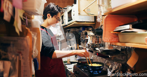 Image of Japanese chef man, cooking and kitchen by stove, service or catering job on pan, pot and ready. Person, restaurant or cafeteria with chopsticks for meal prep, working or thinking for recipe in Tokyo