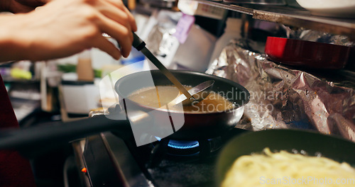 Image of Cooking, sauce and person with pan on gas stove at food market for meal preparation, eating and nutrition. Restaurant, flame and closeup of utensils to prepare lunch, cuisine dinner and supper