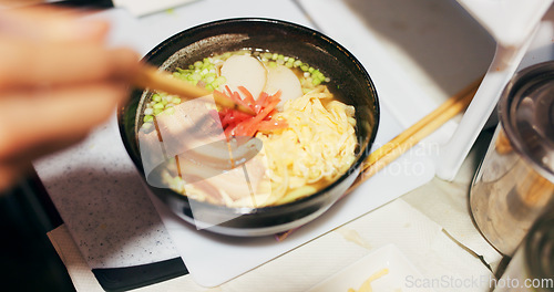 Image of Ramen food, plate and table in restaurant with person, hands and ginger with closeup for Japanese cuisine. Niboshi bowl, chopsticks and pork for diet, nutrition and catering for wellness in Tokyo