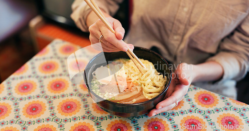 Image of Ramen food, plate and table in restaurant with person, hands and ginger with closeup for Japanese cuisine. Niboshi bowl, chopsticks and pork for diet, nutrition and catering for wellness in Tokyo