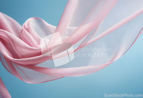 Image of Flying pink fabric wave on blue sky background and illuminated b