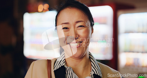 Image of Japanese business woman, night and face with funny smile, laughing and excited by vending machine. Person, corporate employee and happy mature worker in dark lobby, workplace and portrait in Osaka