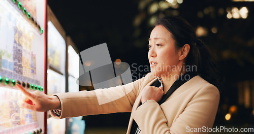 Image of Woman, thinking and choice at vending machine for food or hot drink with in city at night. Shopping, automatic service and customer with click button and press on decision downtown in Tokyo Japan